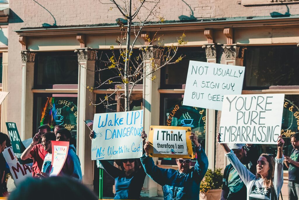 Demonstrators hold creative signs during a lively protest in Wheeling, WV.